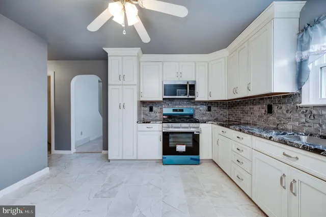 a kitchen with stainless steel appliances granite countertop a stove and a sink