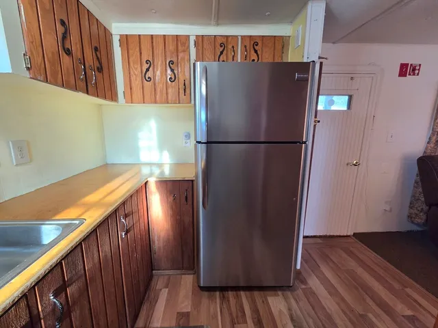 a kitchen with wooden cabinets a sink and dishwasher