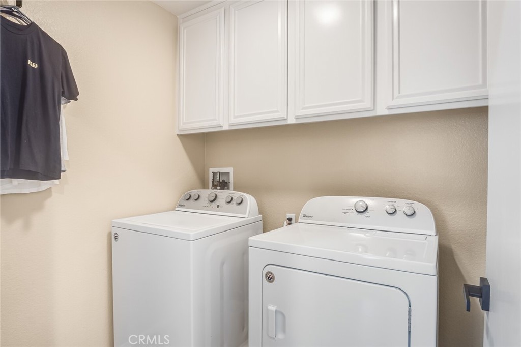 4330 Forest Ranch Way Oceanside, CA 92057 - Photo 33 of 51 Tucked conveniently away on this level, the utility room is designed with practicality in mind. Built-in cabinets provide generous storage for laundry essentials and household items.
