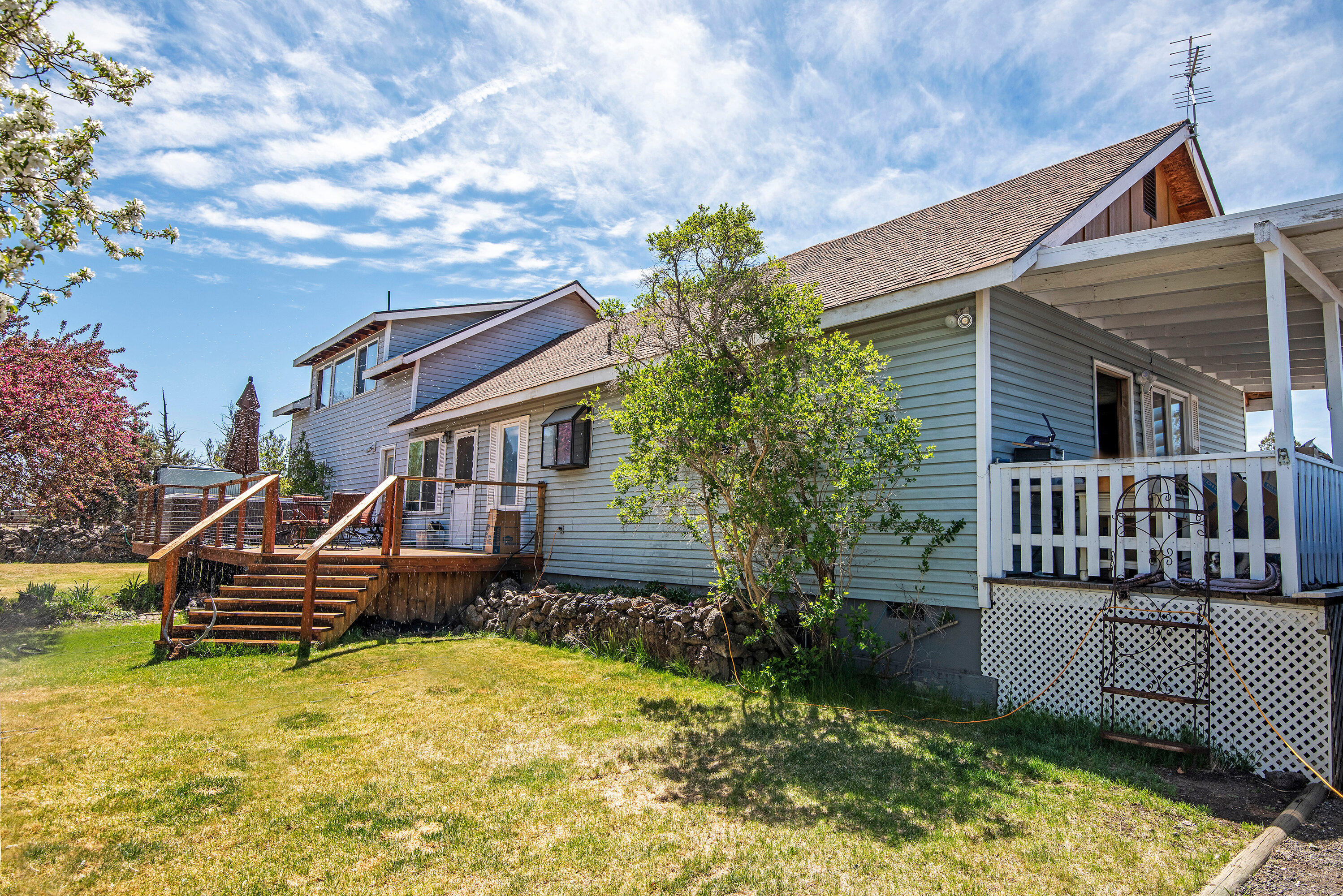 63591 Gentry Loop Bend, OR 97701 - Photo 4 of 24 a small house with a wooden deck and furniture