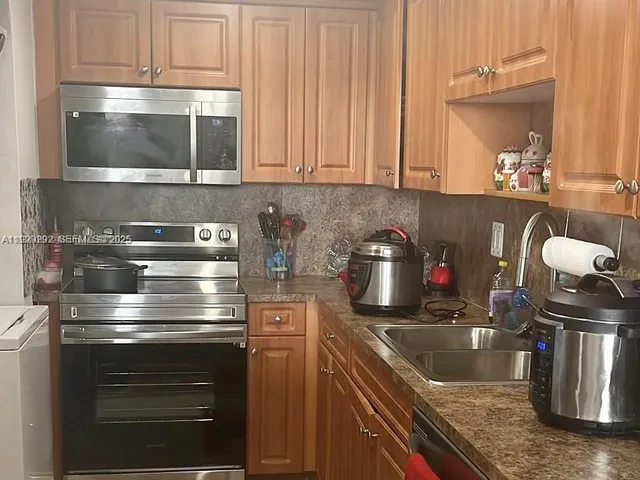 a kitchen with a stove and a sink