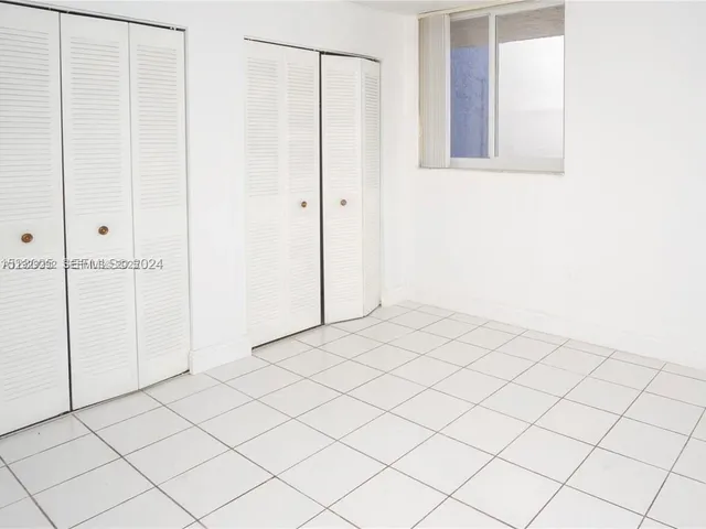 a view of a utility room with cabinet