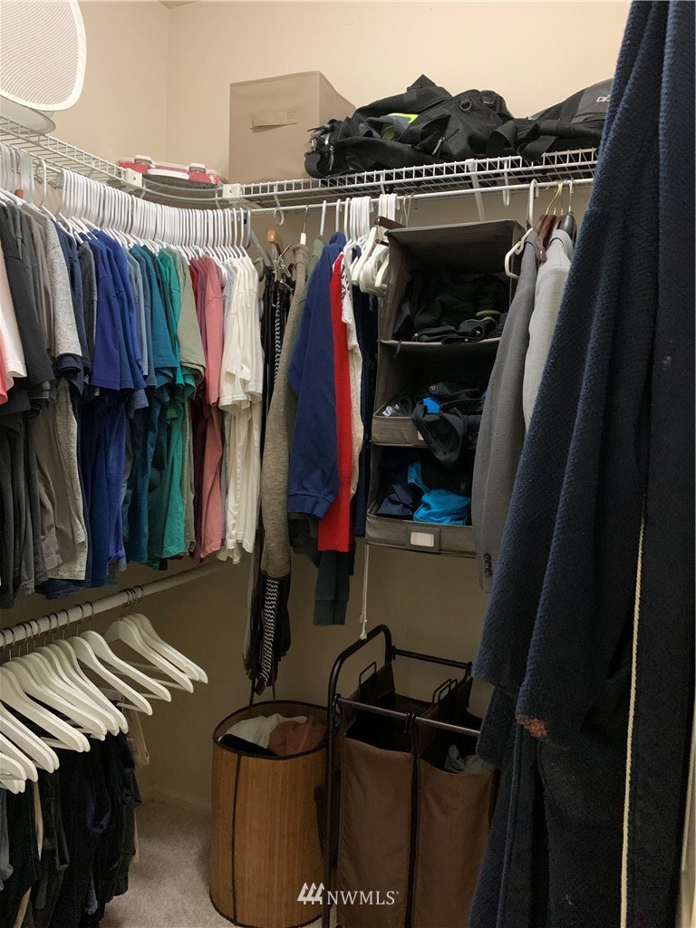 4818 Davis Place South, Unit H Renton, WA 98055 - Photo 8 of 20 a view of walk in closet with clothes and shoes