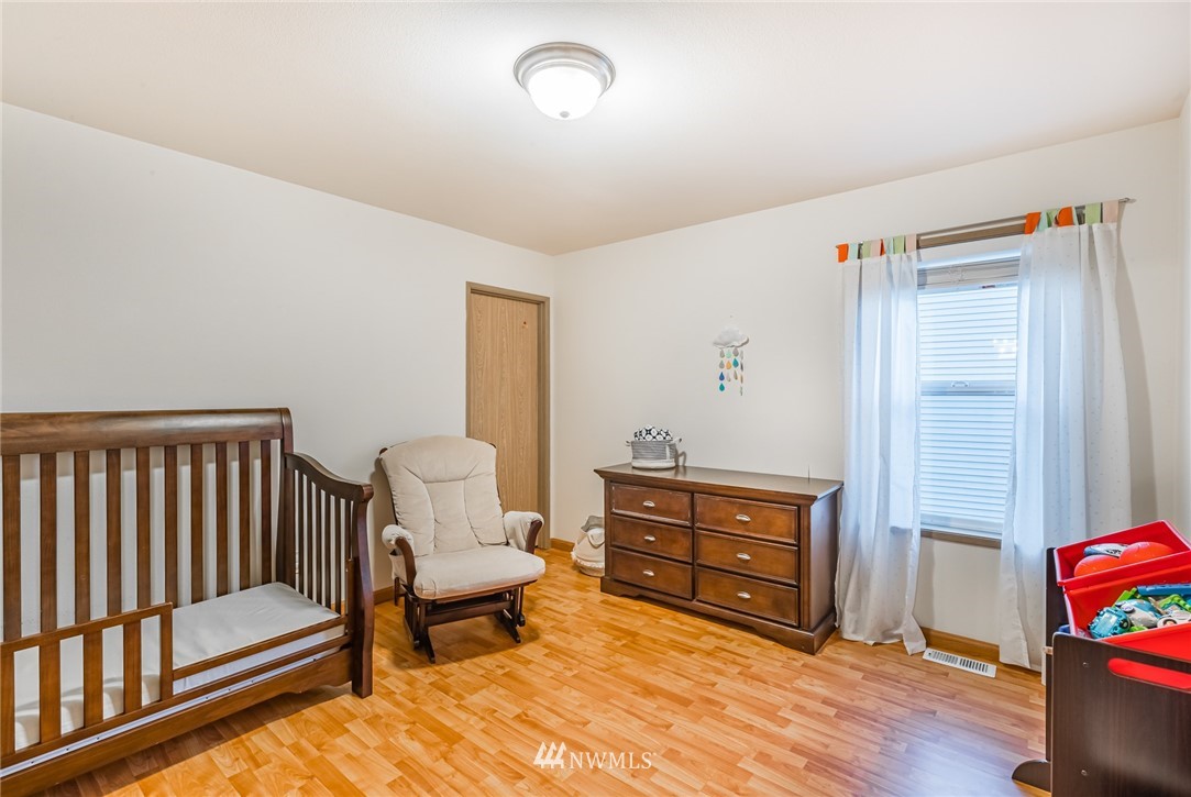 20426 Corbridge Road Southeast Monroe, WA 98272 - Photo 17 of 23 a bedroom with a bed and wooden floor