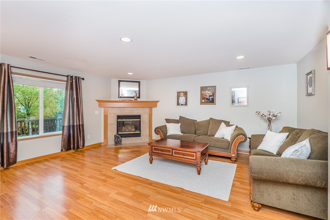 20426 Corbridge Road Southeast Monroe, WA 98272 - Photo 6 of 23 a living room with furniture and a fireplace
