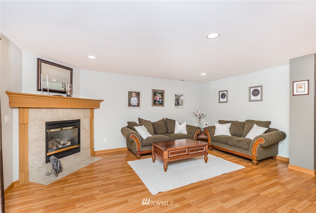 20426 Corbridge Road Southeast Monroe, WA 98272 - Photo 7 of 23 a living room with furniture and a fireplace