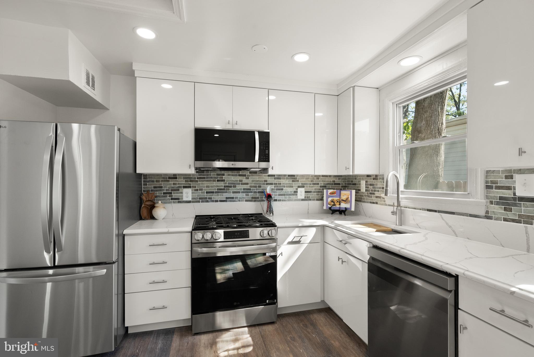 28 East Reed Avenue Alexandria, VA 22305 - Photo 11 of 33 a kitchen with a refrigerator stove and sink
