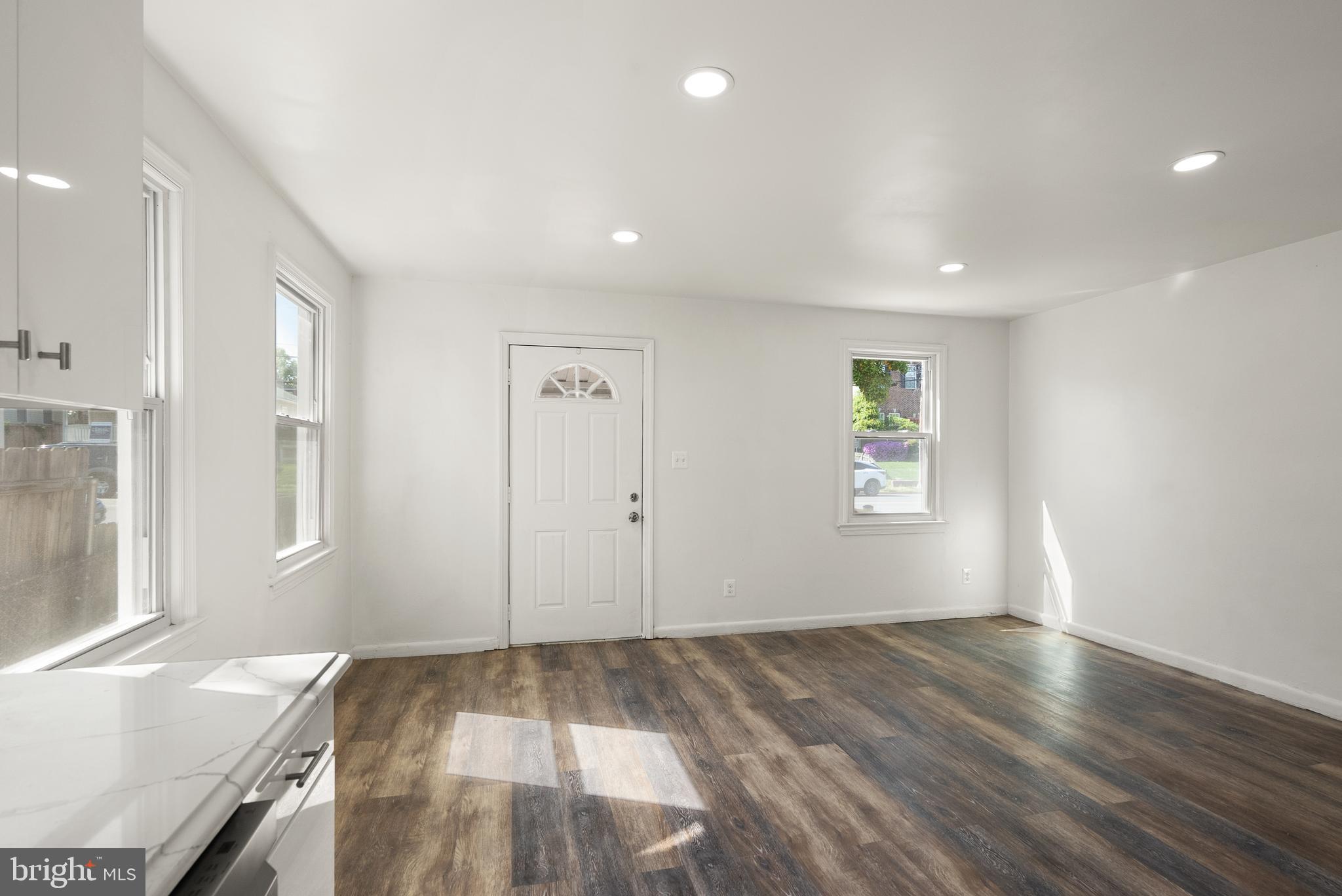 28 East Reed Avenue Alexandria, VA 22305 - Photo 12 of 33 an empty room with wooden floor and windows