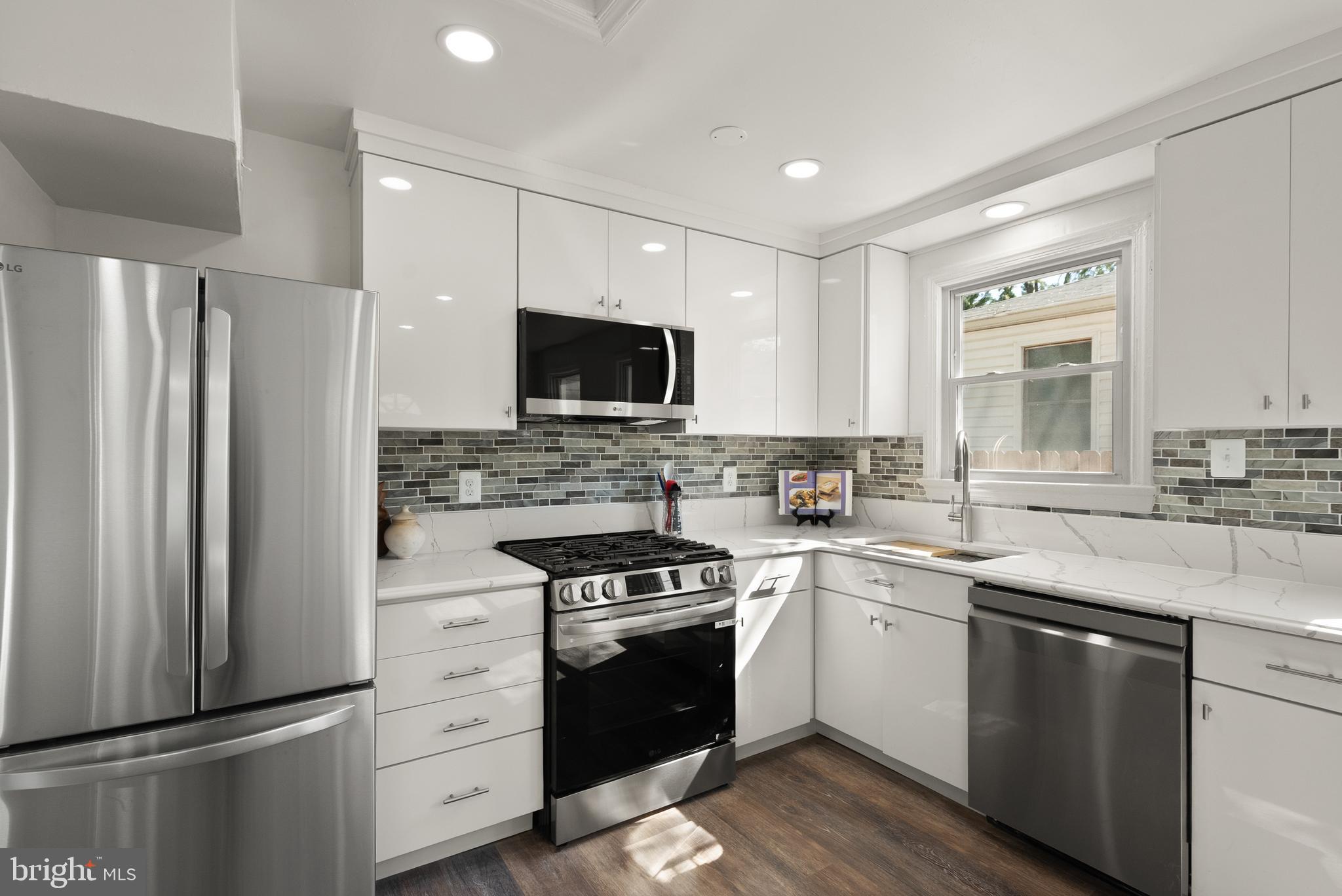 28 East Reed Avenue Alexandria, VA 22305 - Photo 13 of 33 a kitchen with a sink stove and refrigerator
