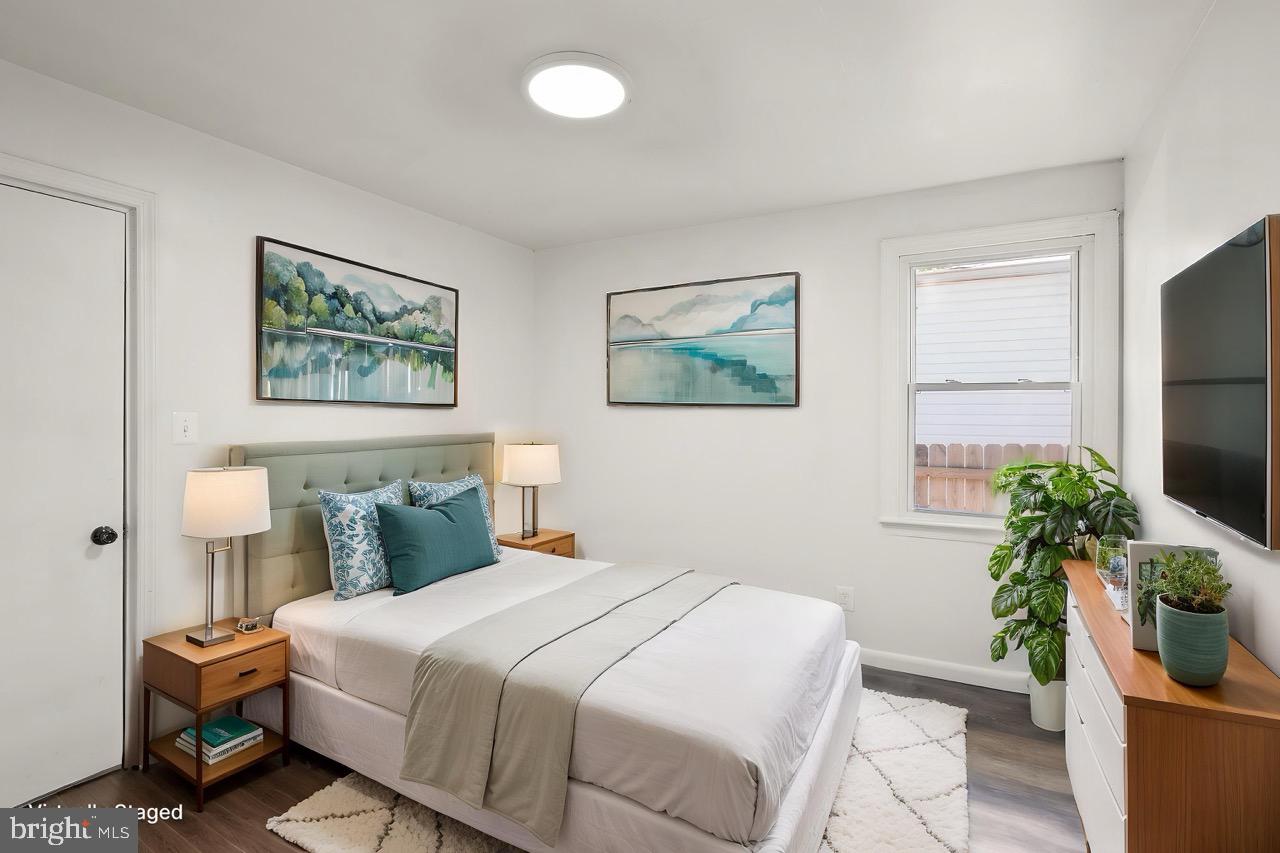 28 East Reed Avenue Alexandria, VA 22305 - Photo 16 of 33 a bedroom with a large bed and a potted plant