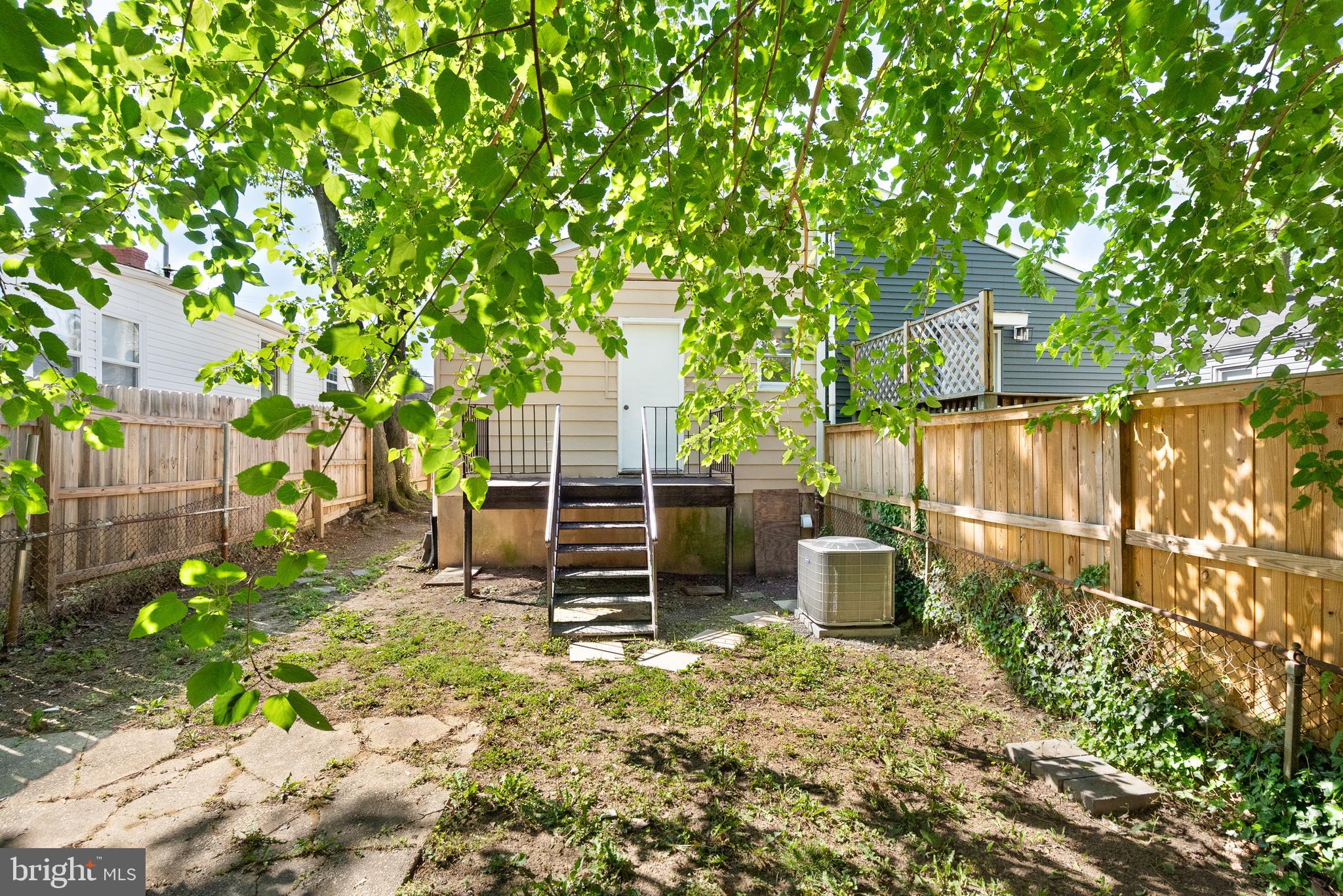 28 East Reed Avenue Alexandria, VA 22305 - Photo 31 of 33 a backyard of a house with barbeque oven table and chairs