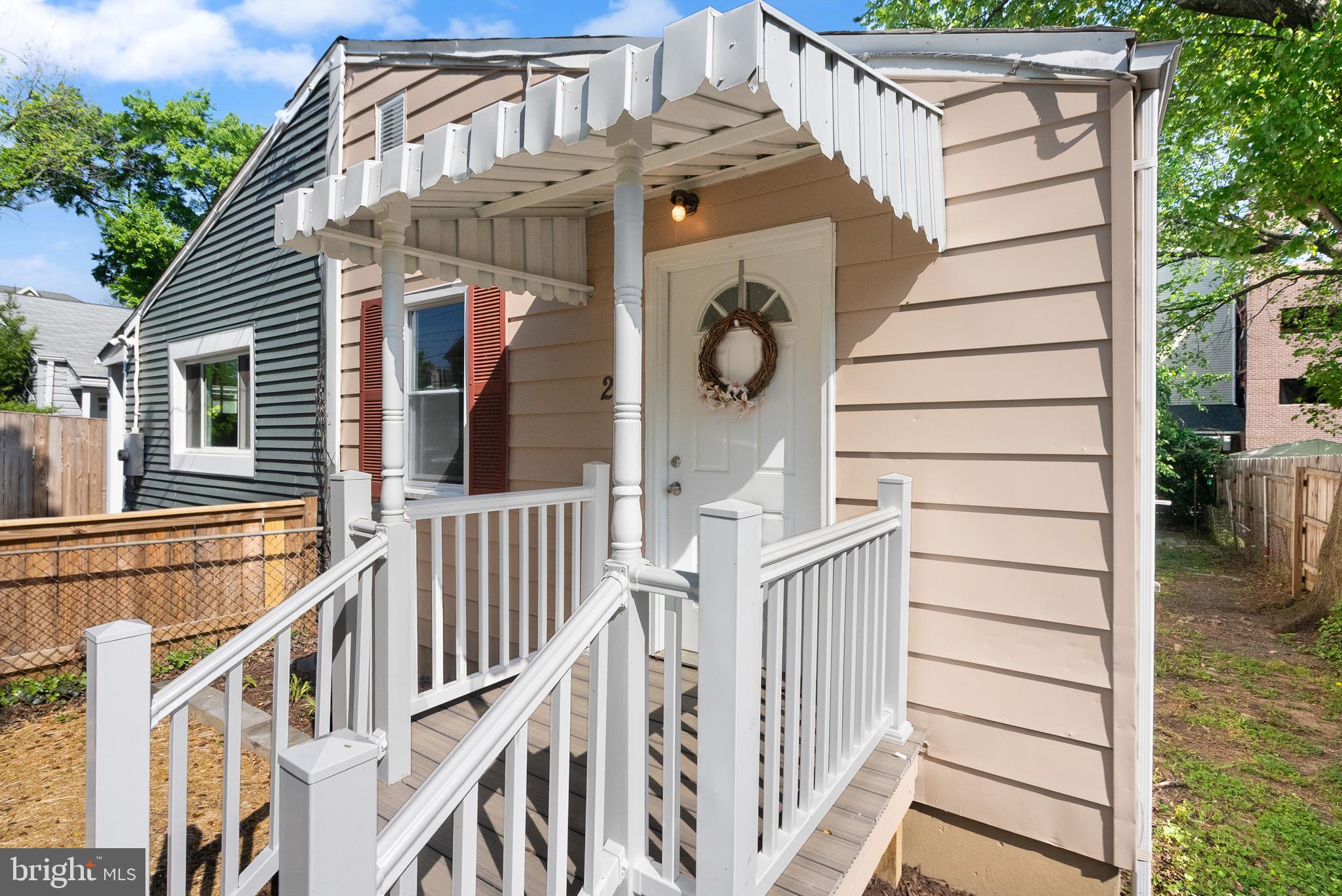28 East Reed Avenue Alexandria, VA 22305 - Photo 8 of 33 a view of a house with a wooden deck stairs and a large tree
