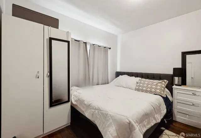 a bedroom with a bed and a chair