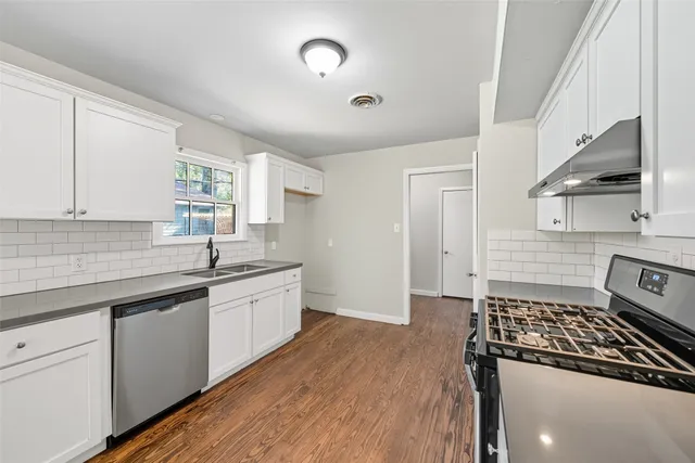 a kitchen with a sink stove and cabinets