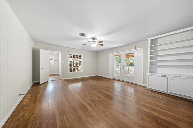 wooden floor in an empty room with a window
