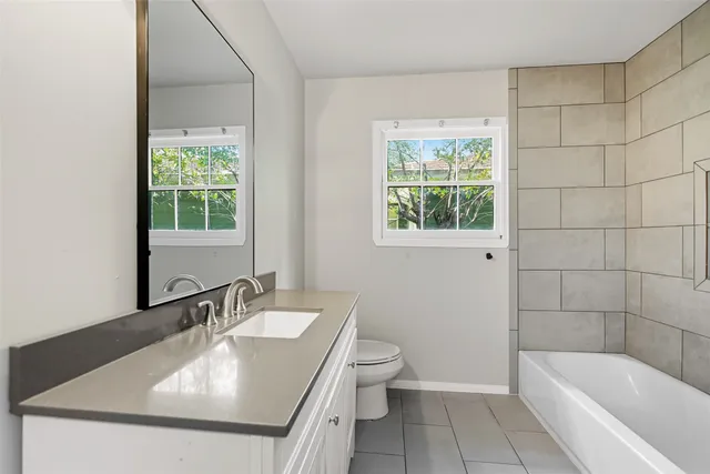 a bathroom with a sink toilet and tub