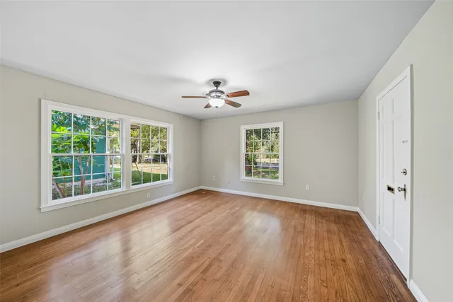 wooden floor in an empty room with a window