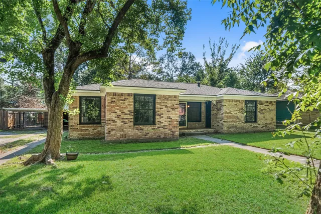 a view of a house with a yard and a garden