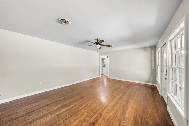 wooden floor in an empty room with a window