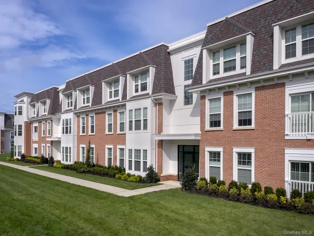 a front view of a building with a yard