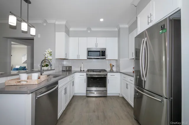 a kitchen with a refrigerator sink and microwave