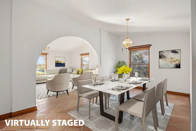 a view of a dining room with furniture a chandelier and wooden floor