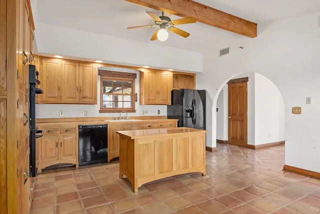 a kitchen with stainless steel appliances a stove a sink and a refrigerator