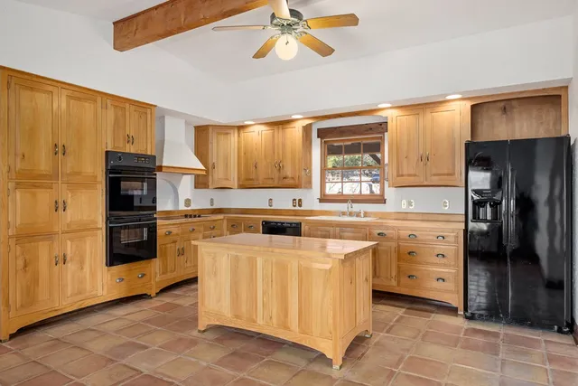 a kitchen with stainless steel appliances a refrigerator sink and cabinets