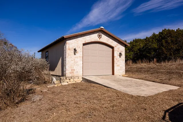 a view of an empty room with wooden floor and windows