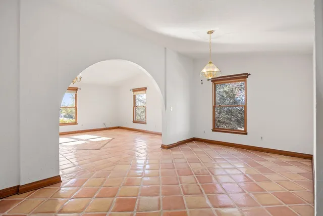 an empty room with windows and entrance