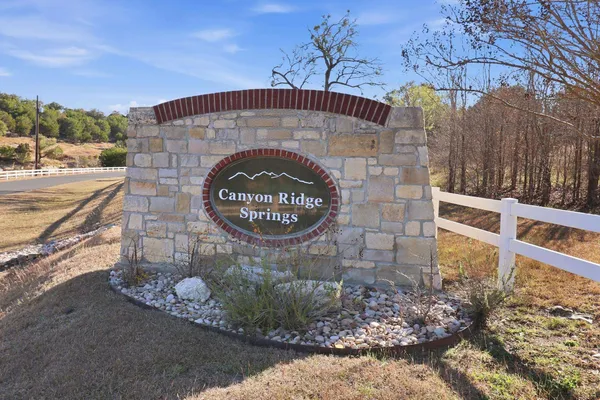 a view of a street with a bench and trees around