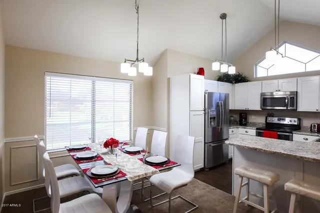 a kitchen with stainless steel appliances kitchen island granite countertop a refrigerator and microwave