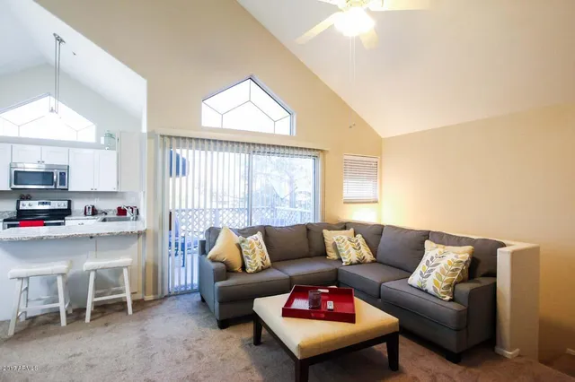 a living room with furniture and a large window
