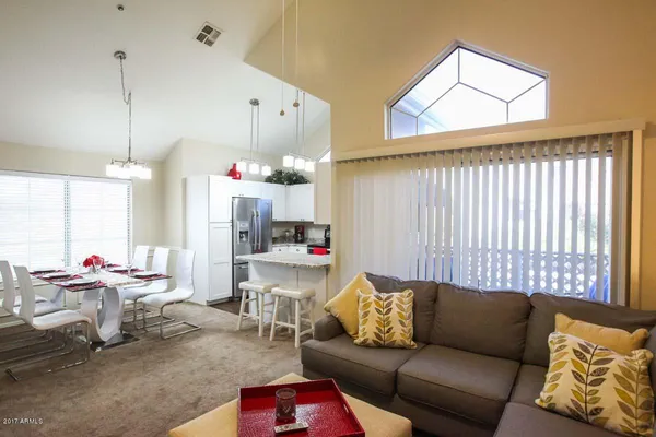 a living room with furniture and a chandelier