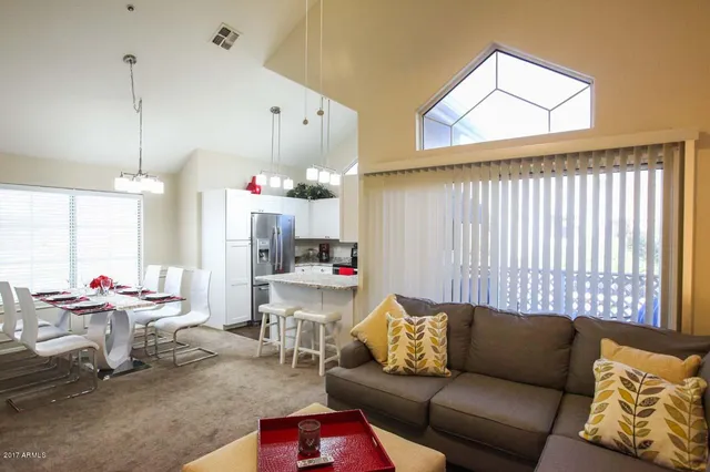 a living room with furniture and a chandelier
