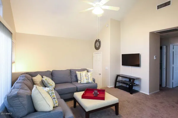 a living room with furniture and a flat screen tv