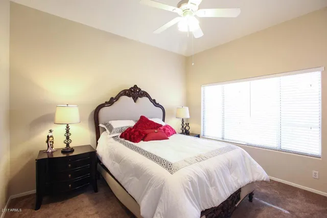 a bedroom with a bed and a chandelier