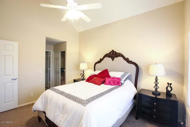 a bedroom with a bed and a chandelier