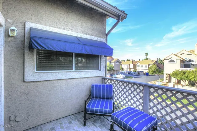 a wooden bench sitting in front of a building
