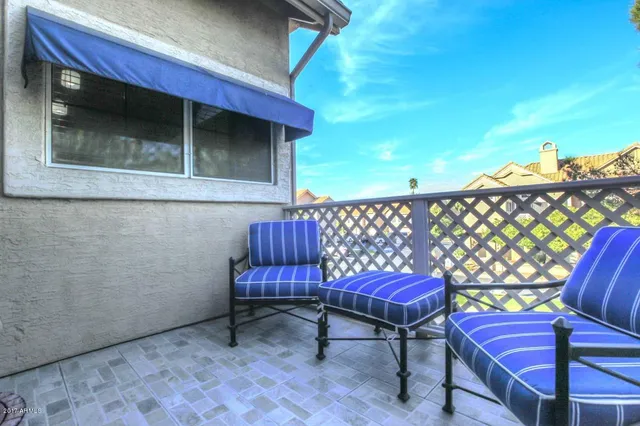 a view of a swimming pool with an outdoor seating and plants