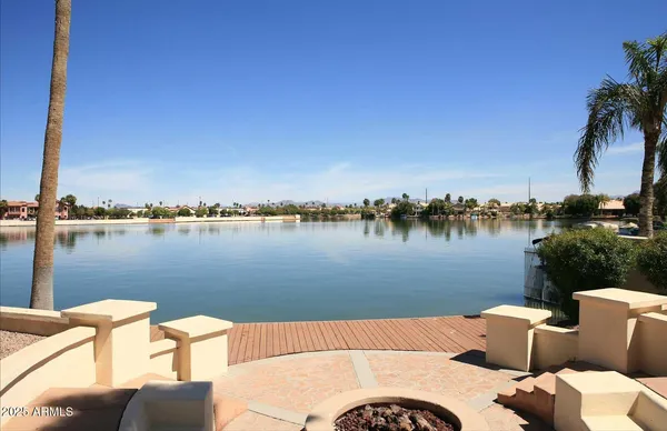an aerial view of residential houses with outdoor space and lake view
