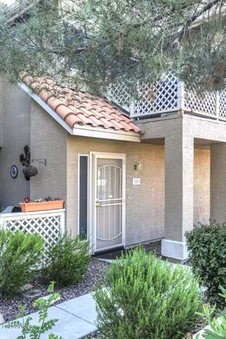 a front view of a house with plants