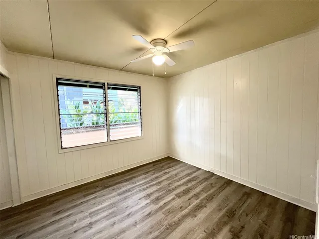 a view of a room with wooden floor and gate