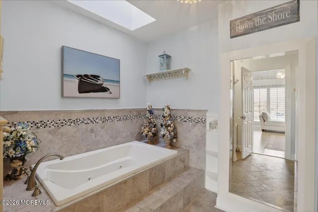 a bathroom with a granite countertop sink vanity and mirror