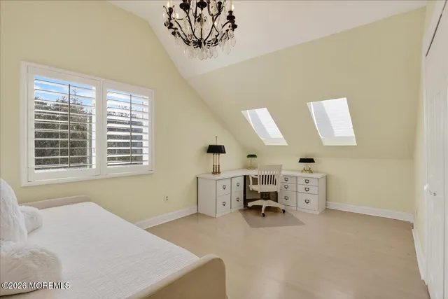 a bedroom with bed and a window