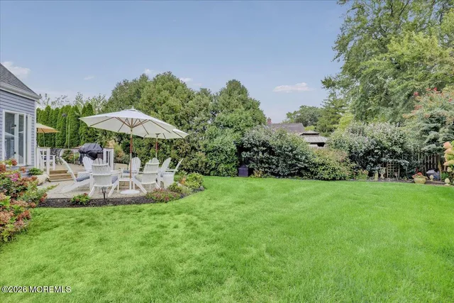 a view of a house with a yard and sitting area