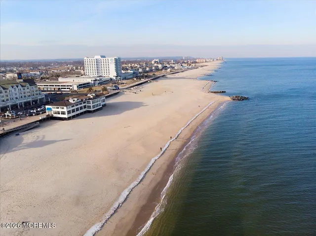 an aerial view of lake residential house with swimming pool and green space