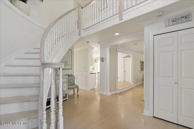 a view of entryway and hall with wooden floor