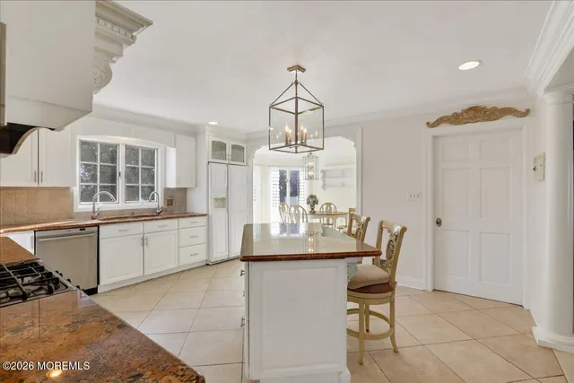 a kitchen with granite countertop stainless steel appliances a sink and cabinets