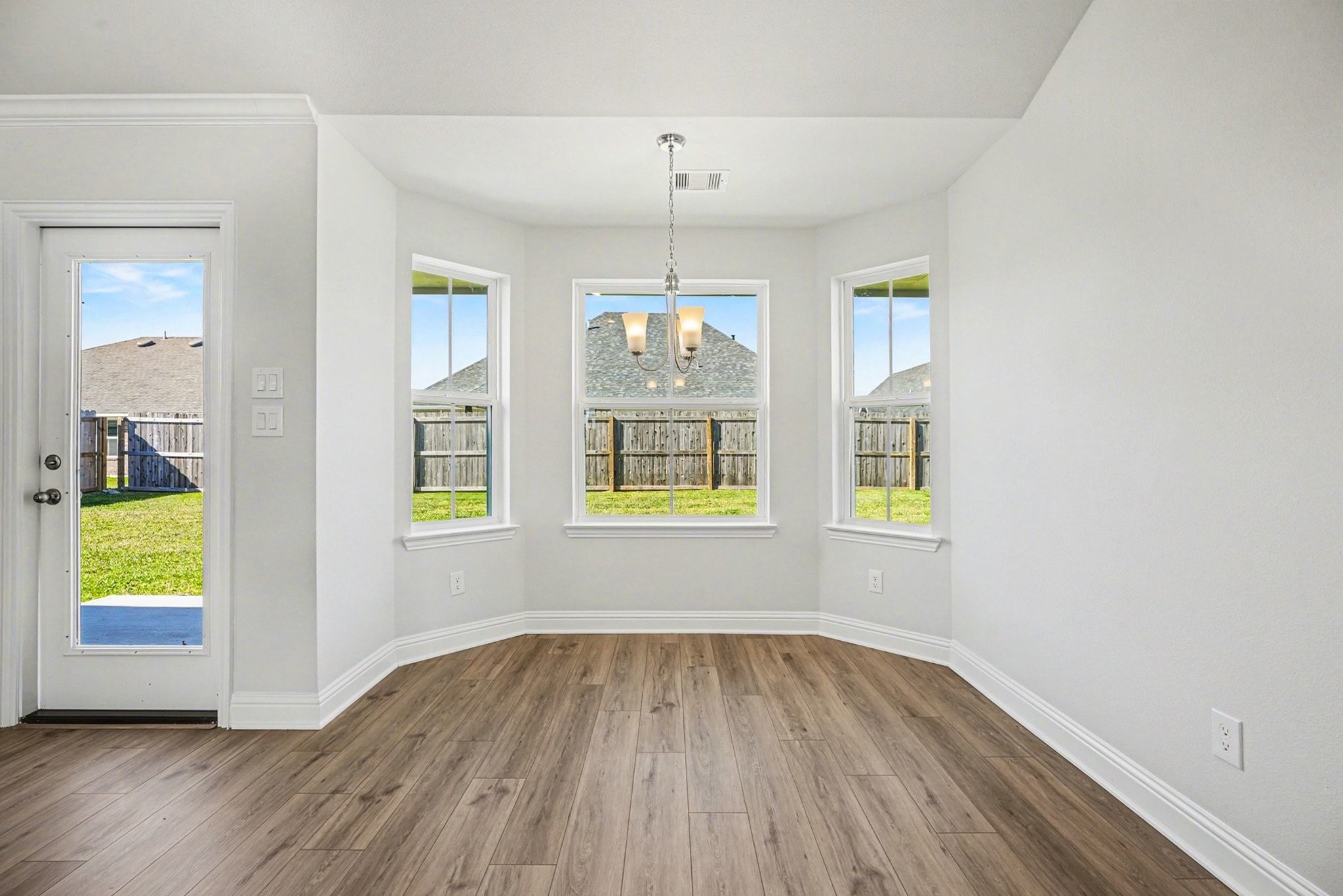 5 Keystone Court Angleton, TX 77515 - Photo 15 of 33 an empty room with window and wooden floor